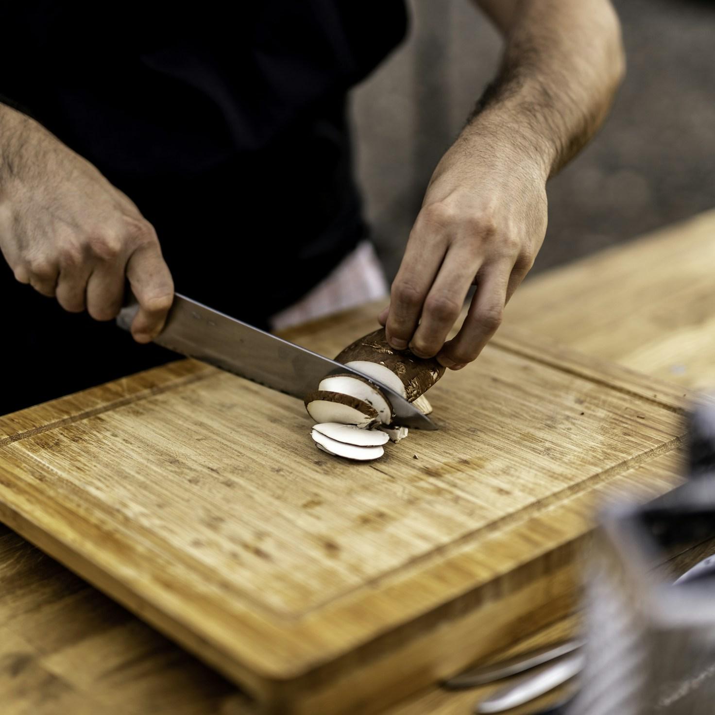 Members collaborating in a contemporary kitchen space, exchanging recipes and techniques